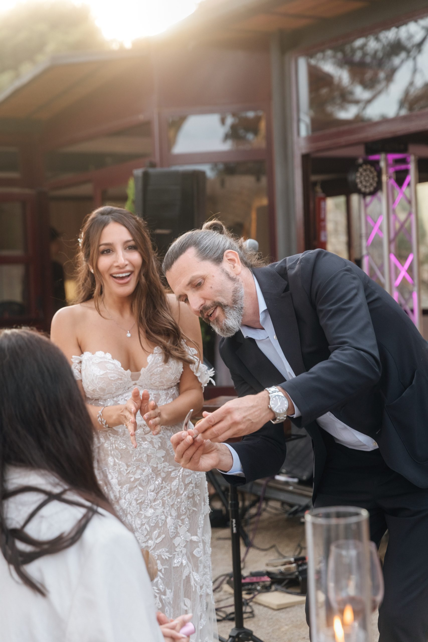 Wedding cocktail hour entertainment with guests reacting to a personalised close-up magic moment